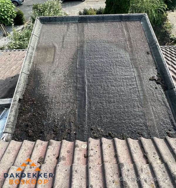 Verouderd plat dak met bitumen en slijtage voor lekkage inspectie in Boskoop Verouderd plat dak met bitumen en slijtage voor lekkage inspectie in Boskoop